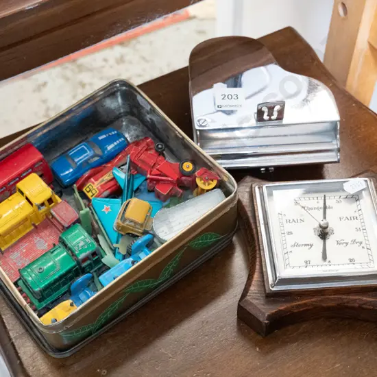 tin of model vehicles, barometer, and a metal piano themed trinket box