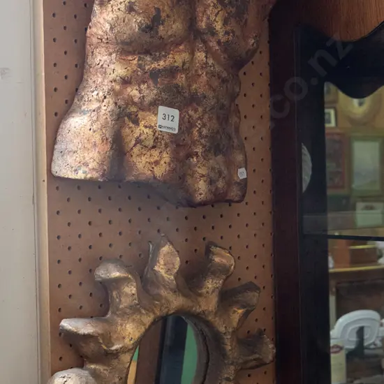 composite wall art and a sun themed wall mirror