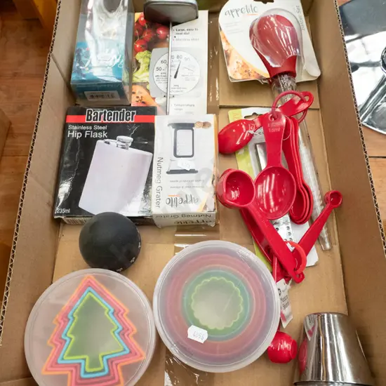 box of as-new cookie cutters, hip flask, meat thermometer, measuring spoons etc.