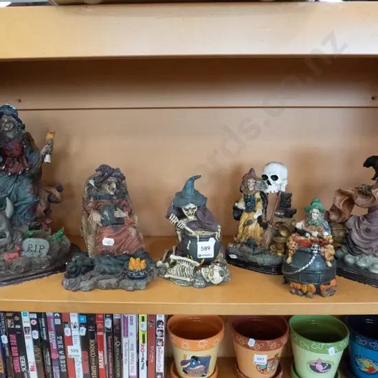 shelf of composite witch figurines