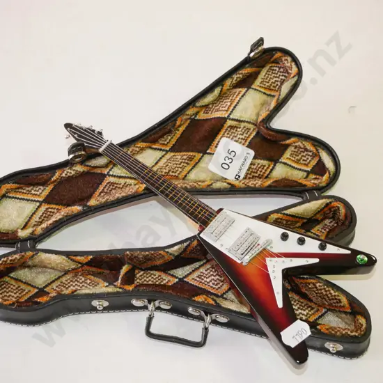 miniature ornamental electric guitar in case