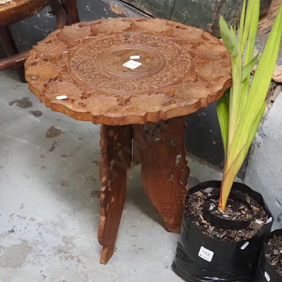 small carved wooden table