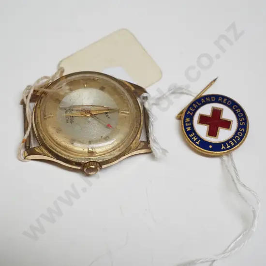 vintage wristwatch and Red Cross badge