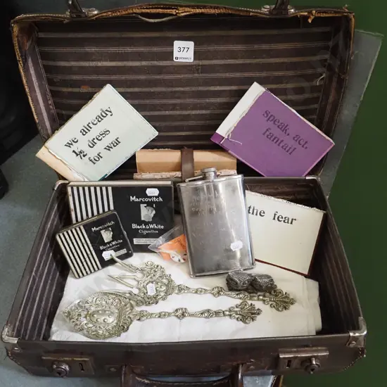 battered suitcase, poetry books etc