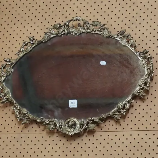 ornate gilt framed oval wall mirror