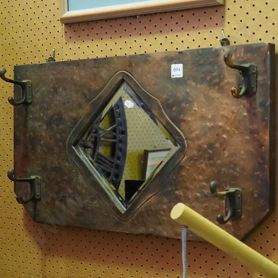 copper wall mounted bevelled edge mirror and coat hooks
