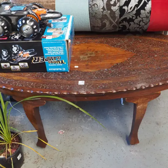 heavily carved middle eastern oval coffee  table with brass inlay