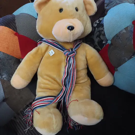 large teddy bear with scarf
