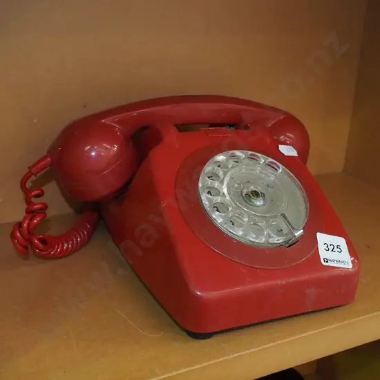 red plastic dial telephone