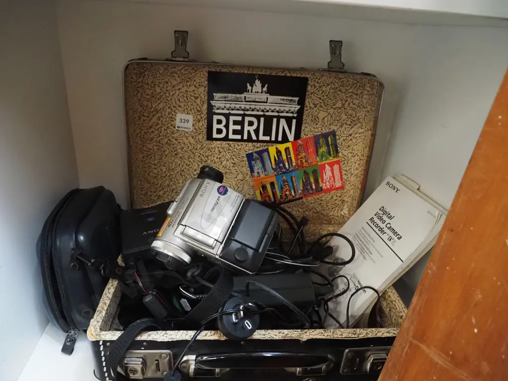 vintage suitcase, various plugs and cords, Sony handi cam Image 1++