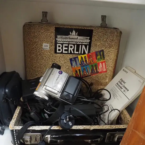 vintage suitcase, various plugs and cords, Sony handi cam