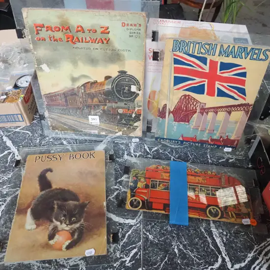 various vintage book covers between pressed glass