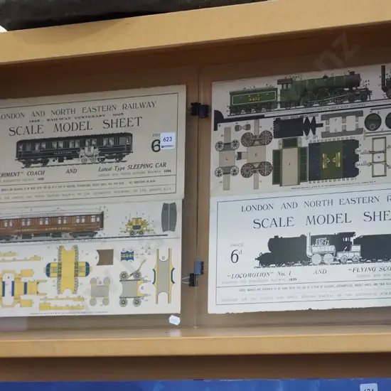 2x train paper cut outs under glass