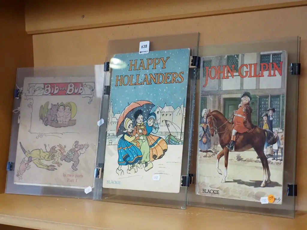 3x vintage book covers under glass Image 1++