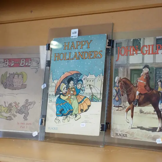 3x vintage book covers under glass