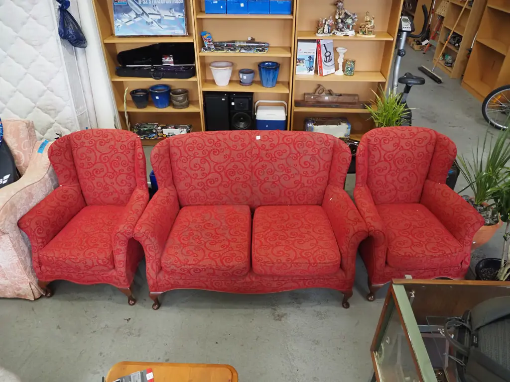 3 piece red upholstered wingback lounge suite - 2 seater, 2 singles - 1 chair has small rip Image 1++