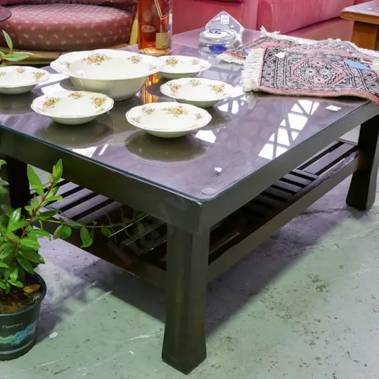 dark stained wooden coffee table with glass top with magazine rack H-445 W-1770