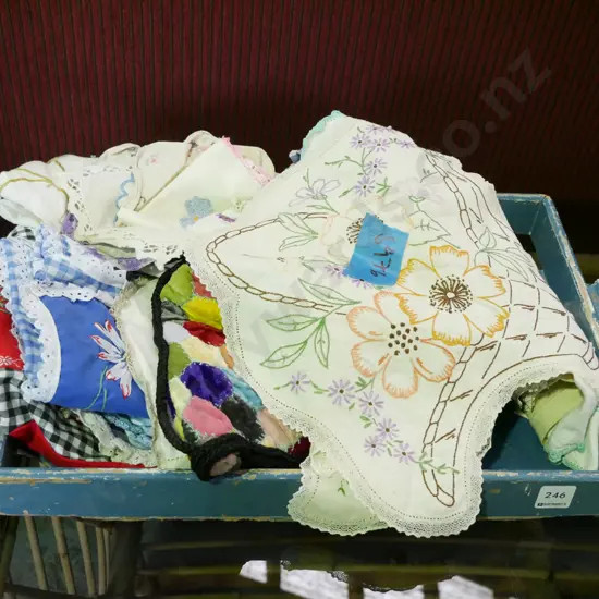 blue painted wooden tray of hand worked linen