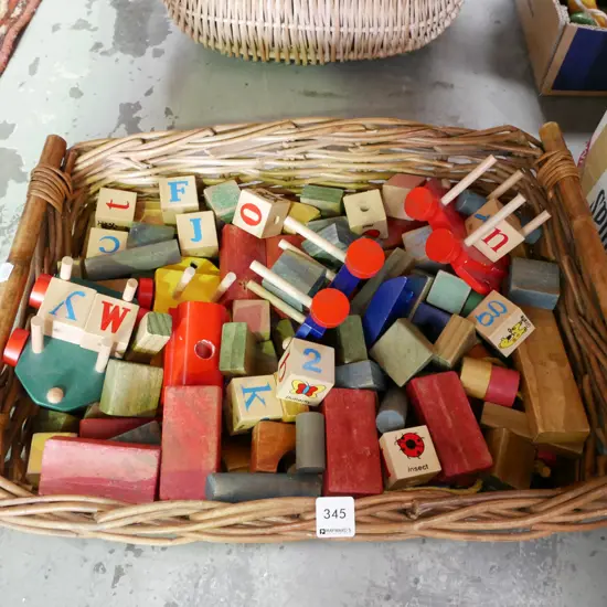 cane basket of wooden blocks 