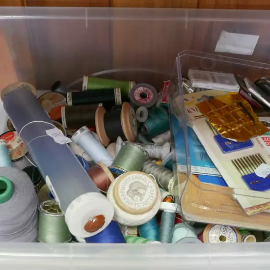 container of threads and sewing accessories