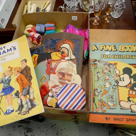 vintage paper Christmas decorations, crate of paper party hats, Just Williams colouring book, Disney book