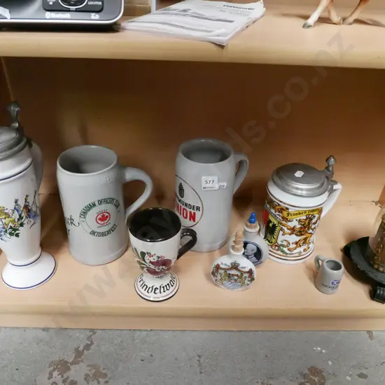 shelf; beer steins, liqueur bottles, souvenir candle