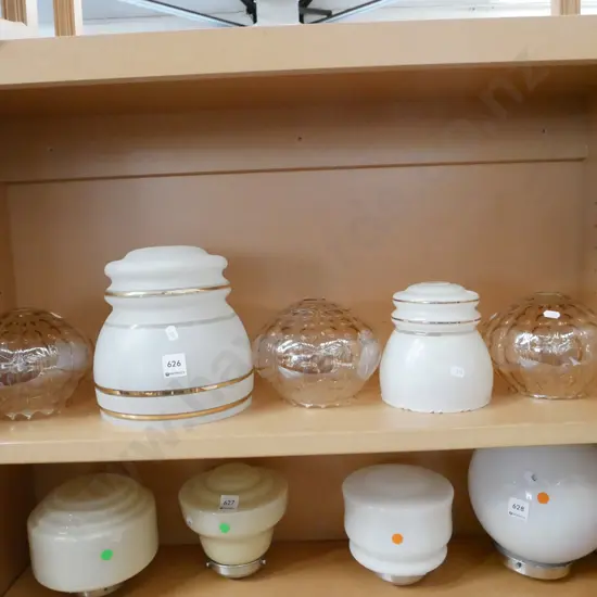 shelf of amber glass and other light shades