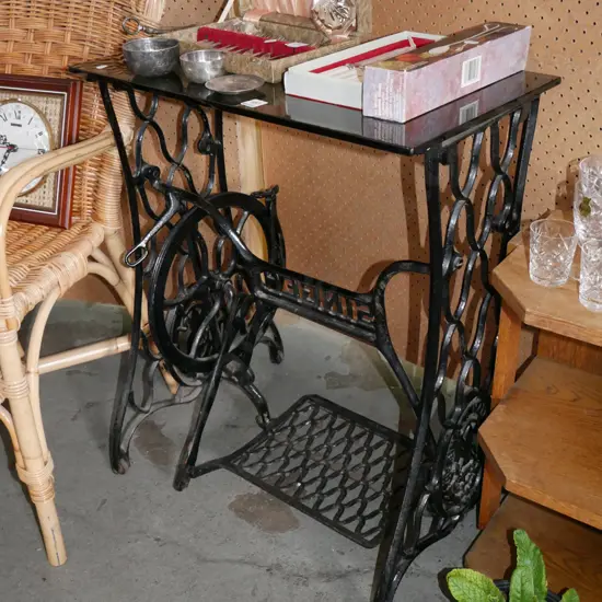 hall table made out of Singer treadle sewing machine base with smoked glass top