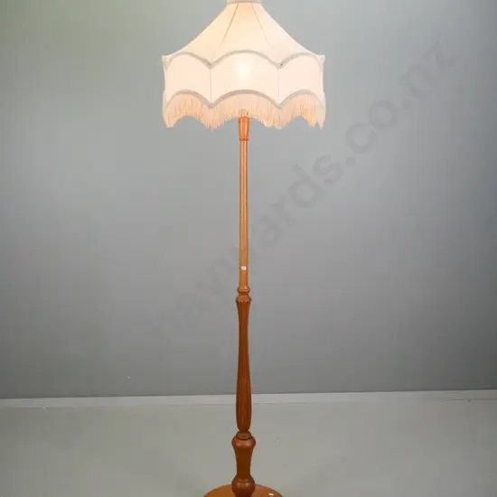 oak standard lamp with turned and fluted column, round base on 3 bun feet, tasseled pagoda shaped shade H-1900
