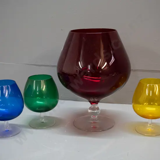 4 clear stemmed coloured glass items - large ruby goblet vase H-245 D-170 and 3 goblets - green, blue and yellow