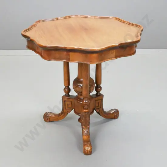 vintage walnut wine or occasional table with shaped edge top, cathedral 3-point base on 3 sweeping carved legs