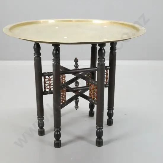 Indian brass tray table on ebonised timber collapsible base, turned shaped legs and turned leg support gallery - tray