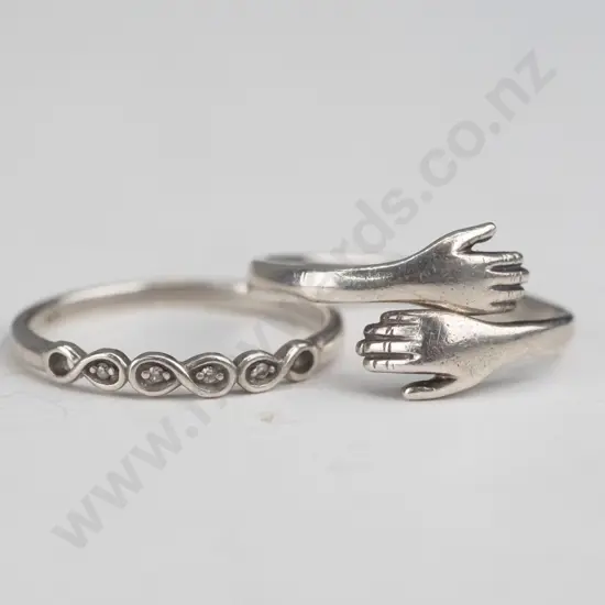 silver ring hands crossover [slighly out of shape] & silver cz ring both stamped 925