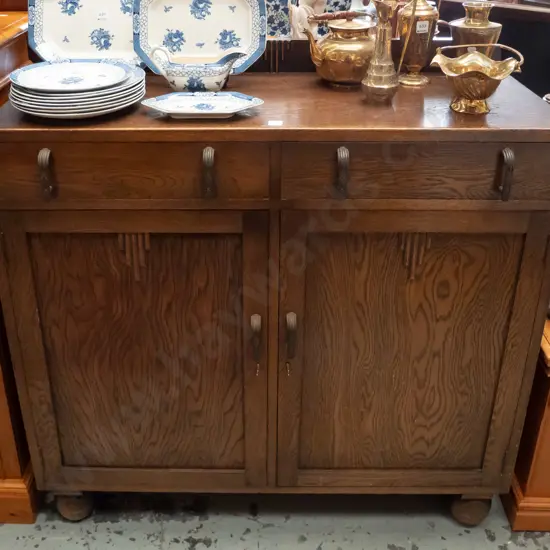 art deco oak sideboard with upstand, 2 drawers and 2 panelled doors, applied wooden decoration, metal handles, on large