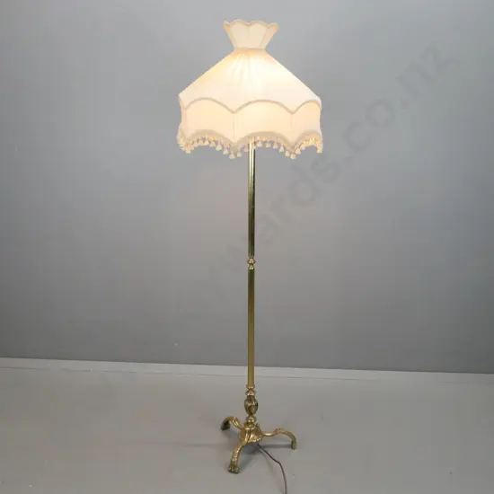 brass standard lamp on 3 shaped foliate feet with waisted fringed shade H-1680 Shade D-510