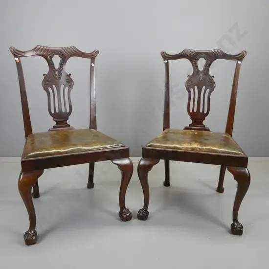 pair of 19th century mahogany Chippendale style chairs with pierced and carved backs, ball and claw feet, w/ olive green