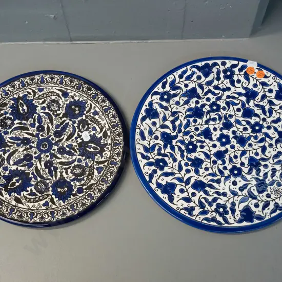 2 Palestinian blue & white display plates from Hebron - with wall hangers - larger is D-300, has small chip near rim on