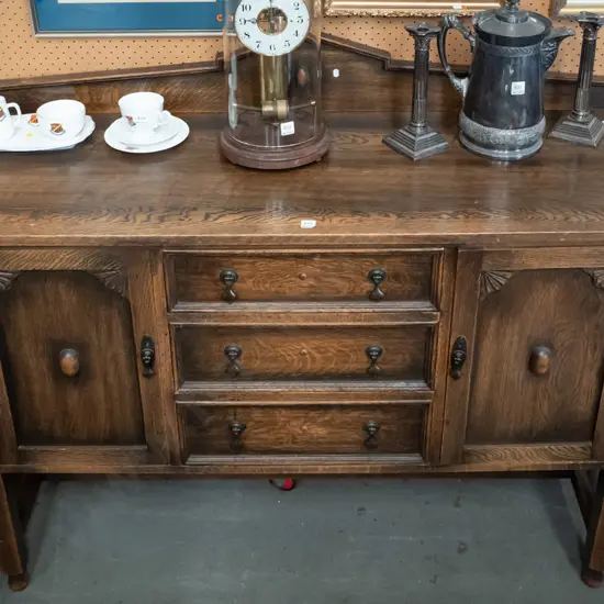 vintage oak Jacobean style sideboard with shaped upstand, 3 central drawer, 2 panelled doors w/fan-shaped corner