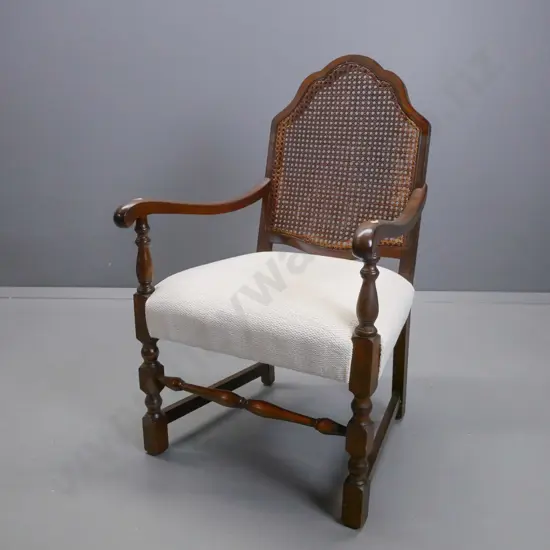 vintage beech open arm side chair with shaped woven cane back, ivory upholstered seat, on turned stretcher base, some