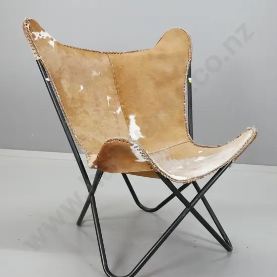 slung cow hide chair on tubular metal x-frame with "Luca" label - leather lacing around edge is fraying & coming apart