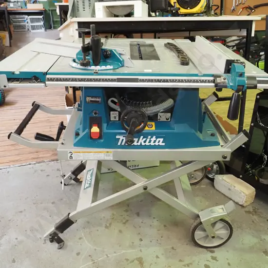 Makita MLT100 1500W table saw on folding wheeled stand