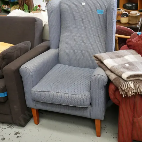 blue striped upholstered wingback fireside chair