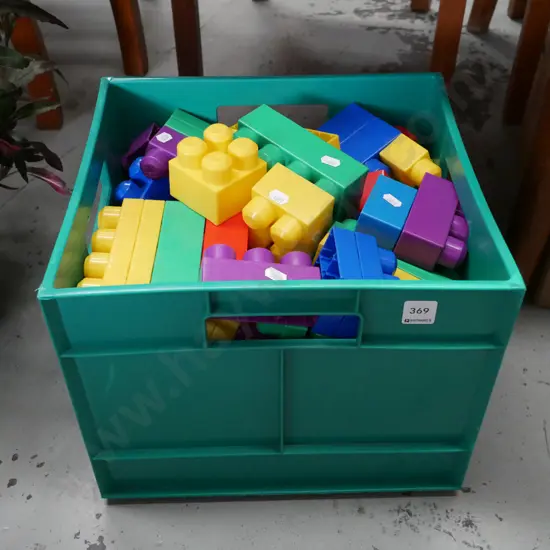 green tub of large plastic building blocks