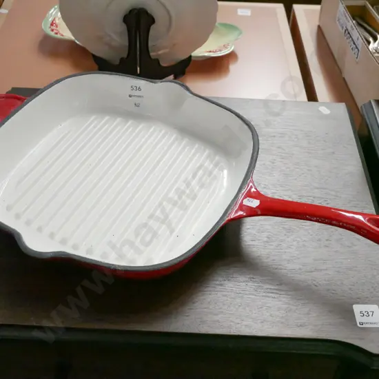 large cast iron and enamel frying pan
