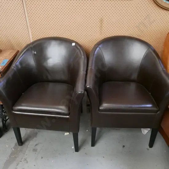 pair of brown vinyl tub chairs