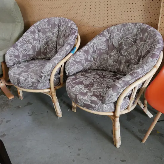 2x bamboo and cane chairs with floral upholstery cushions