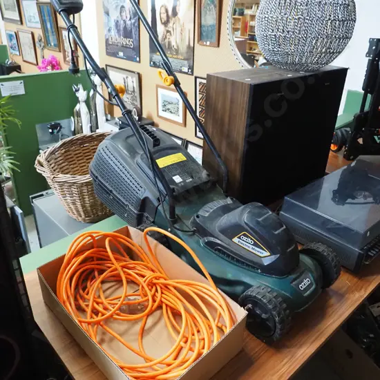 Ozito electric corded lawn mower with large orange extension cord