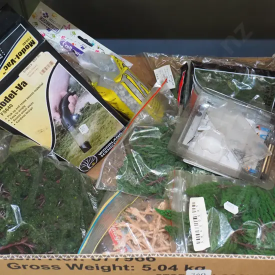 box; model train layout; trees, stones, small vacuum etc