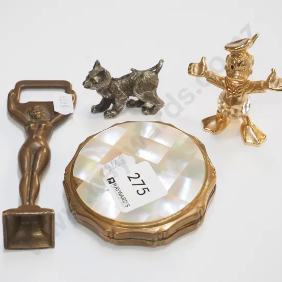 powder compact, bottle opener, Donald Duck figurine, cat figurine
