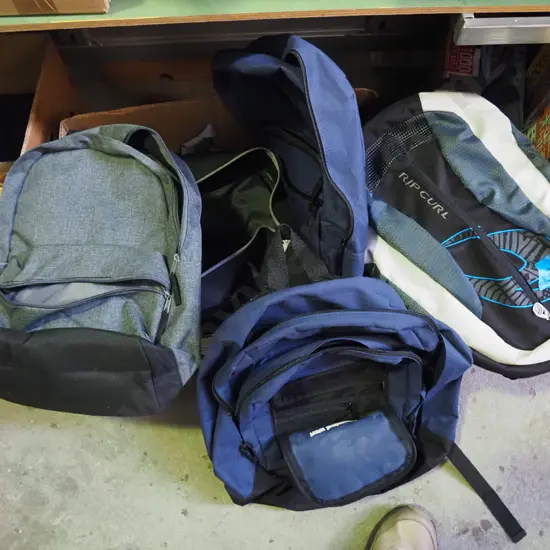 box of various backpacks